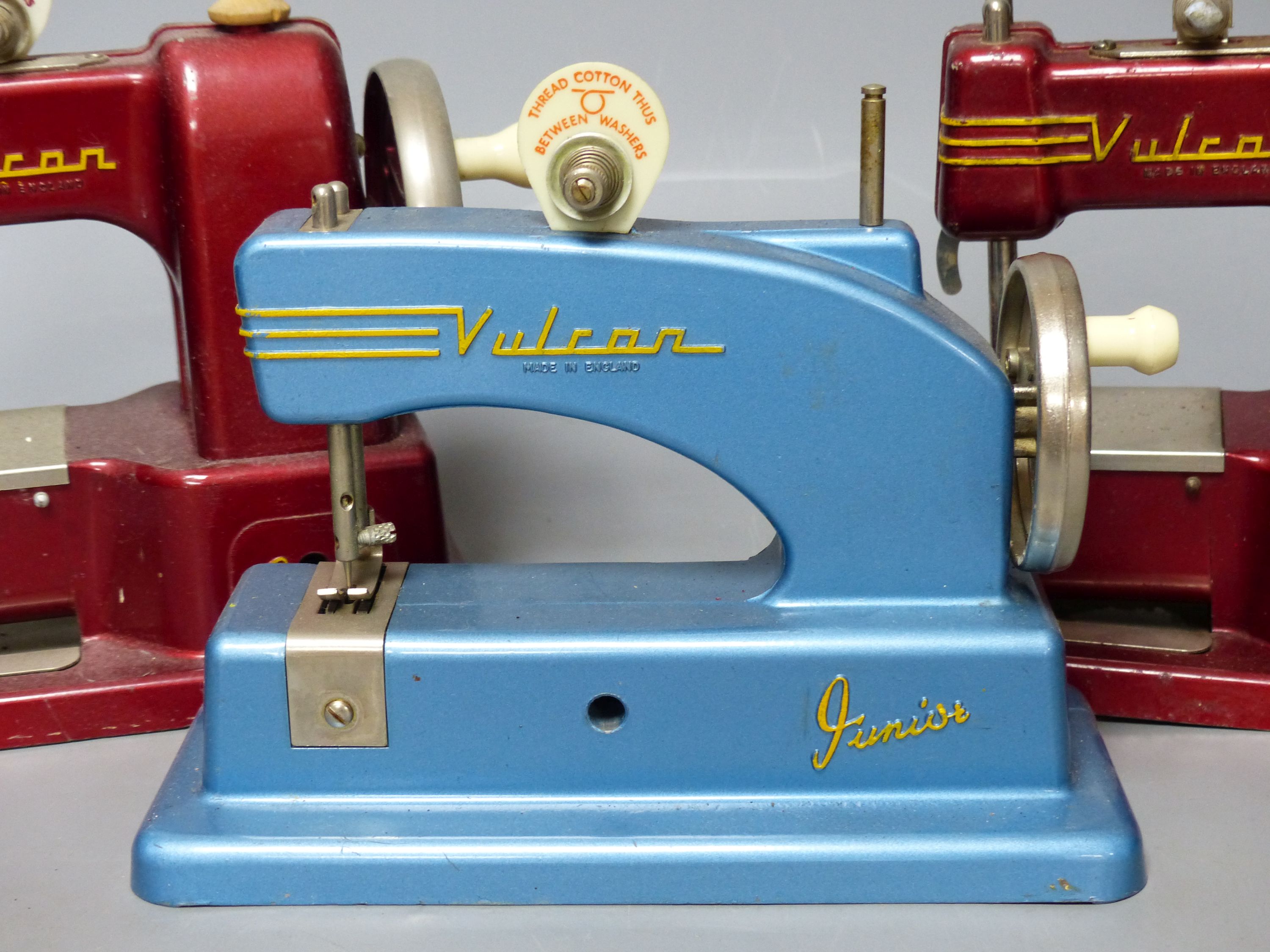 Three vintage hand sewing machines